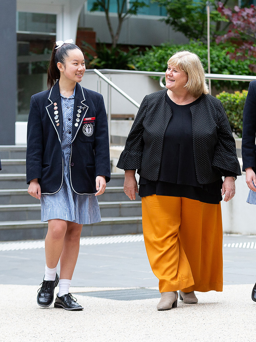 Principal Debbie Dunwoody walking with senior students